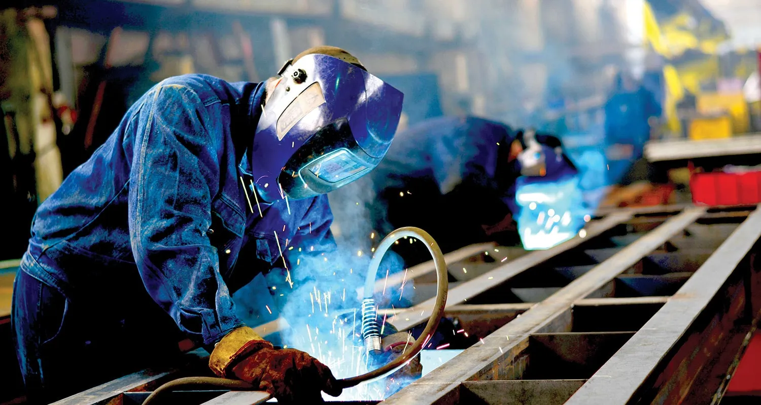 an industrial area where two men are engaged in manufacturing